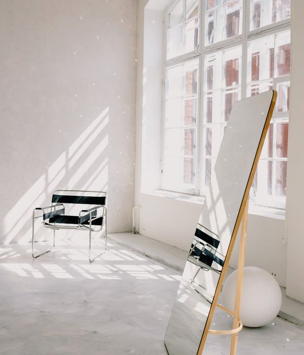Person meditating peacefully in a bright, airy room with natural light.